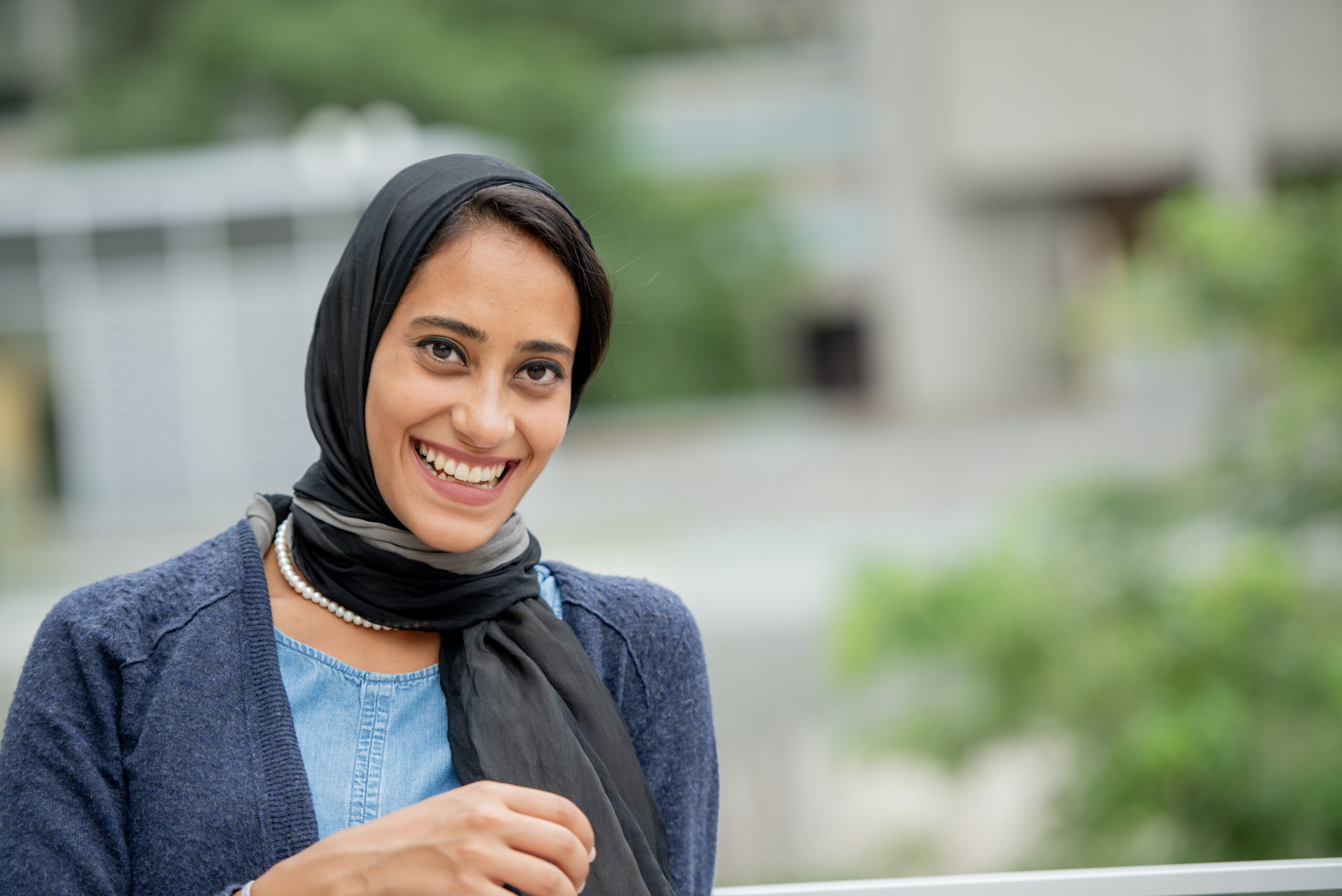Smiling Professional Woman in Hijab in Urban Outdoor Setting